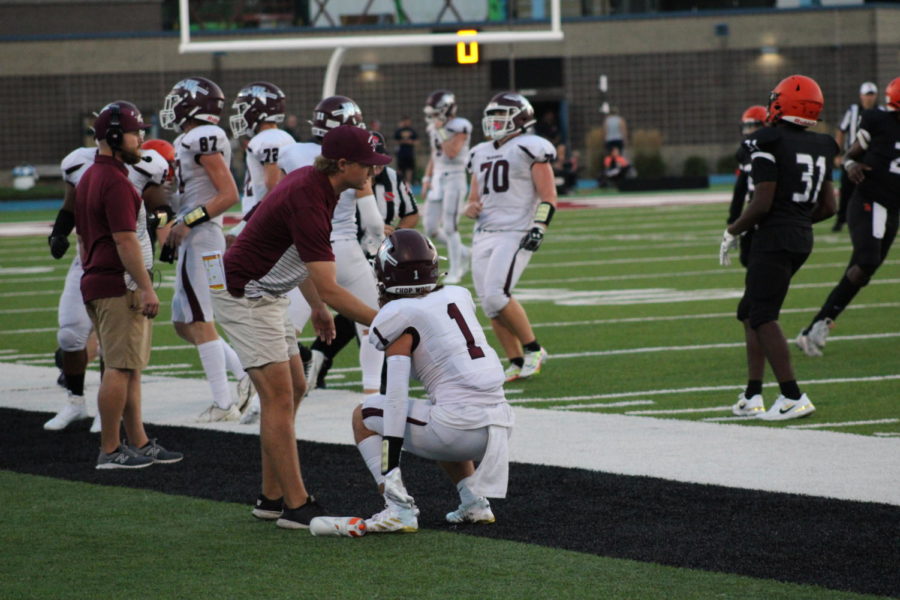 Wahawk Coach White coaching saftey Jacob Muller after the play.