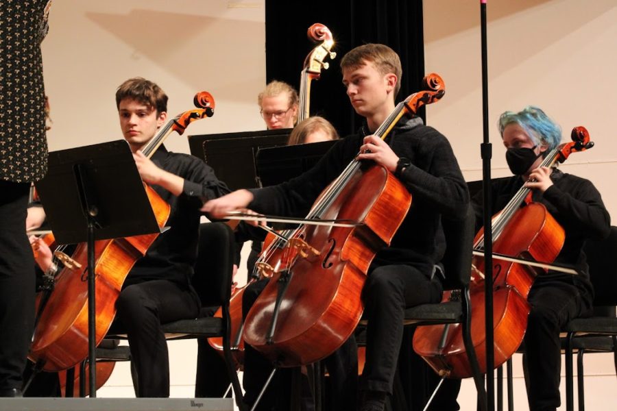 Zephaniah playing the cello during the Symphony Strings performance.