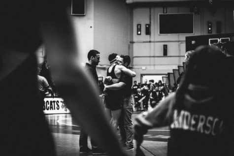 Senior Cooper Paxton hugs Assistant Coach Chad Smith after winning his third place match, guaranteeing his sport at state for the 2022-23 season.