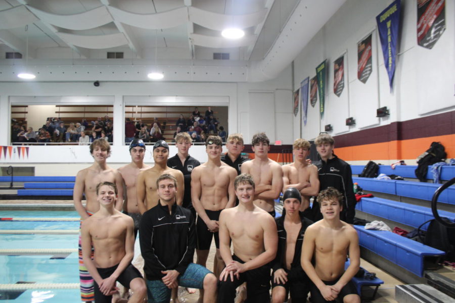 Sabanagic (front left, second person) posing with the swim team for a group picture.