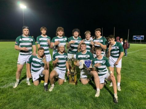 Columbus boys rugby team poses with the state champion trophy for the fourth year in a row, continuing their winning streak from 2019. 
