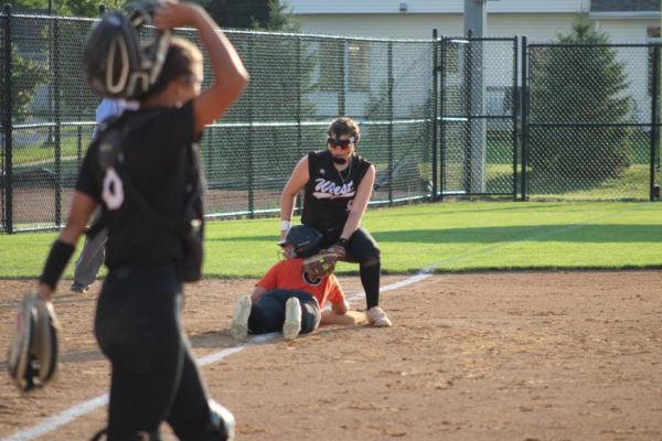 Senior Sydney Wilson attempts to tag out an Ames runner at third base.