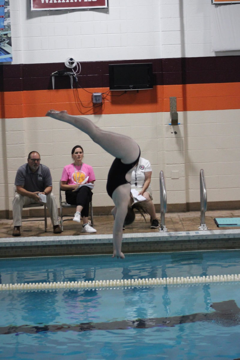 Senior Kaitlyn Cronan finishes her Inward Dive against Iowa City West on Tuesday, September 5.