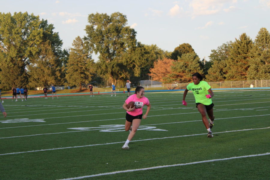 Savannah Ringheden running through the 20 yard line with Sahara Williams right behind.