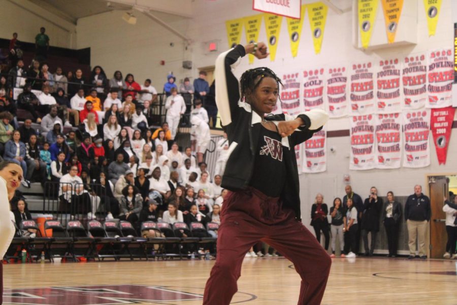 Senior Gabe Fraizer makes his entrance while the dance team performs their state dance at the East v West basketball game.