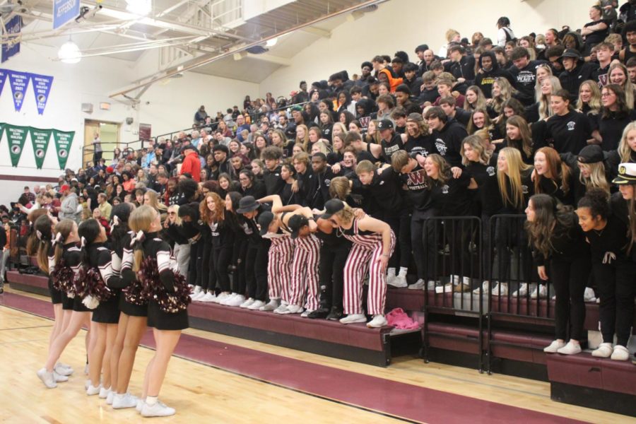 Student section joins in with the basketball cheerleaders to perform Marching During the East v West game 