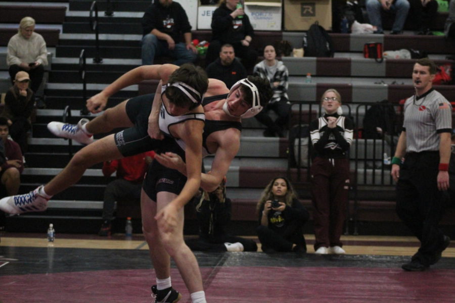 Senior Cooper Paxton spotted during a mid-air suplex while taking down his opponent from Waterloo Columbus Catholic High School. 