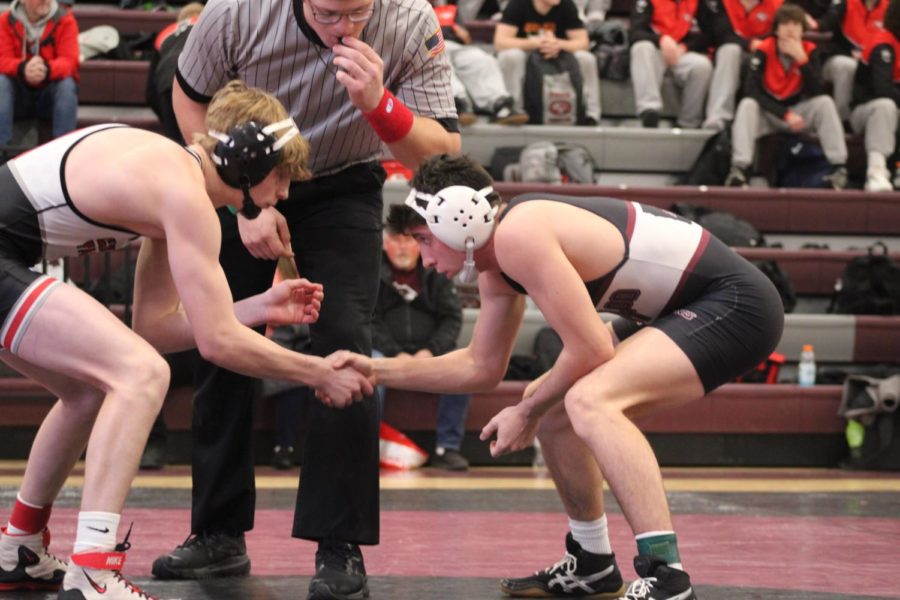 Senior Cooper Paxton shakes hands with his opponent from Cedar Falls High at the Metro tournament 