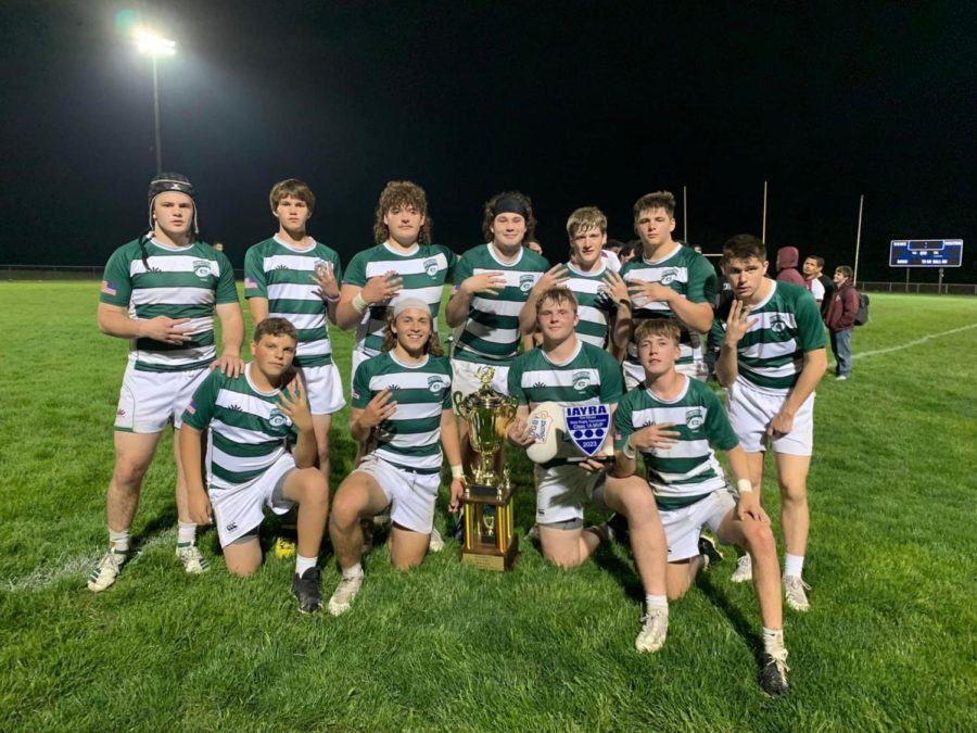 Columbus+boys+rugby+team+poses+with+the+state+champion+trophy+for+the+fourth+year+in+a+row%2C+continuing+their+winning+streak+from+2019.+