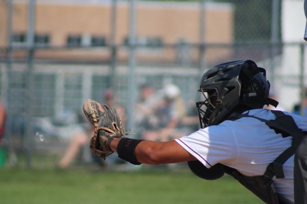 Junior Tayvon Homolar holds out his glove to catch a pitch from his teammate as Cedar Rapids Prairie is up to bat.
