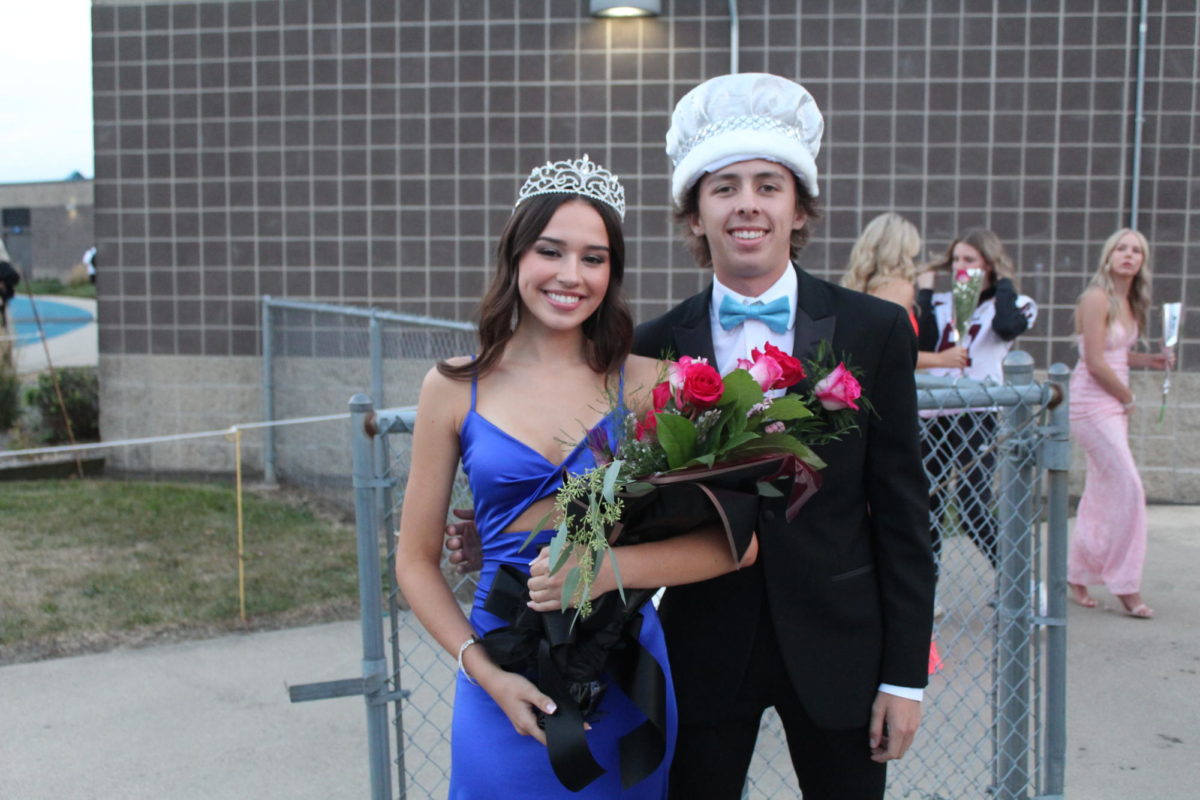 Seniors Ava Holmes and Talan Nelson pose together with their crowns after the Homecoming coronation.