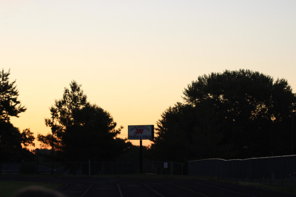 The sun slowing over the trees during senior sunrise on September 1st, 2023
