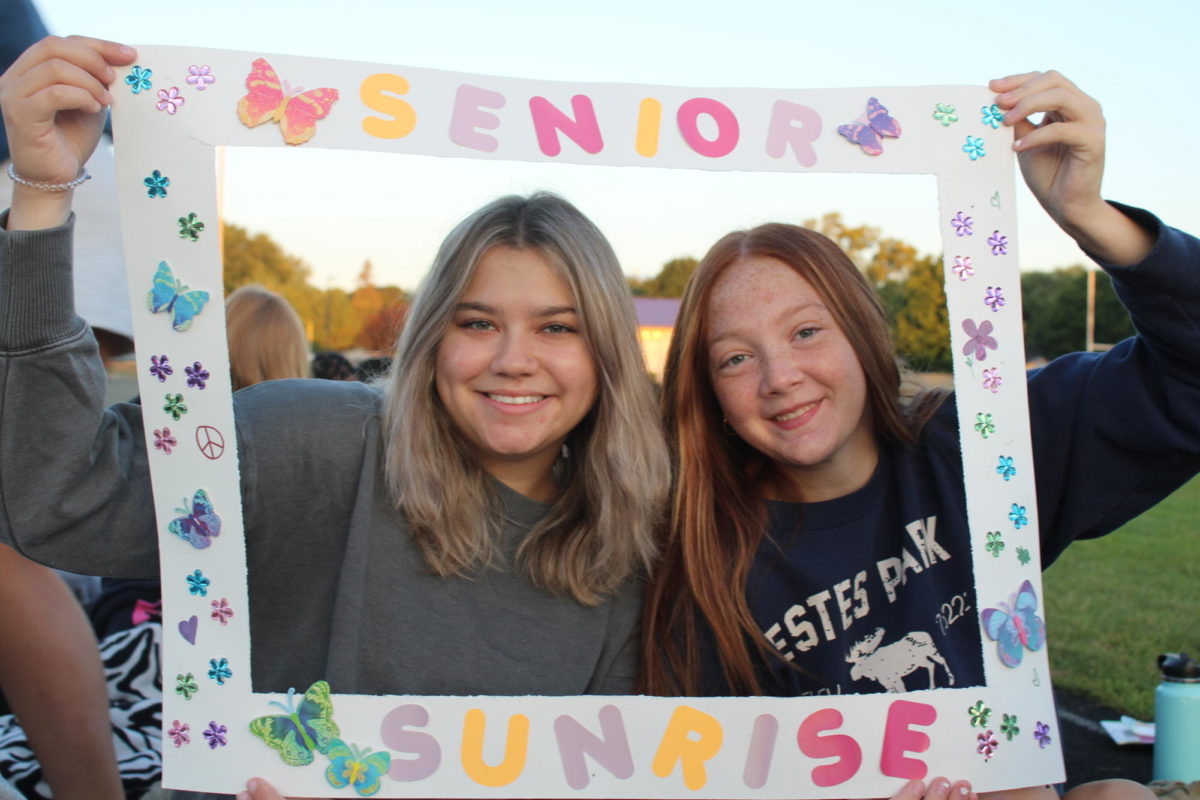 Selma Sabic and Olivia Whittmayer pose with a frame during senior sunrise on September 1st, 2023.