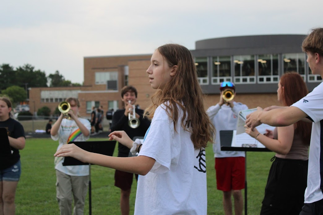 Drum major Millie Gracia conducting sections of the band.