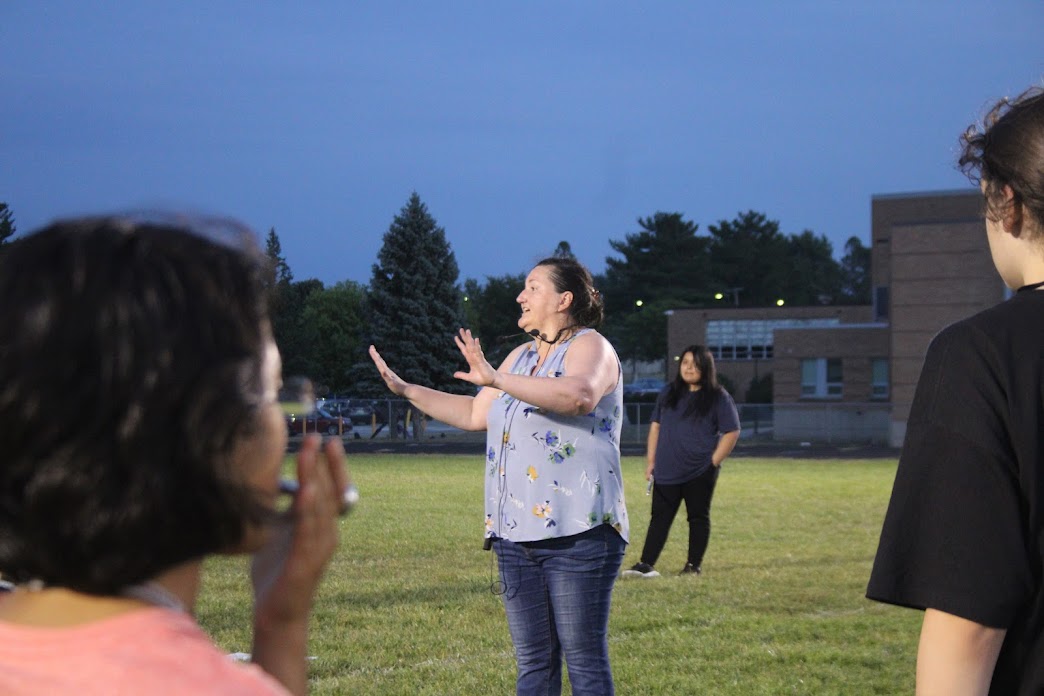 Volunteer band director Janelle Ewing providing critiques to the band during night practice.