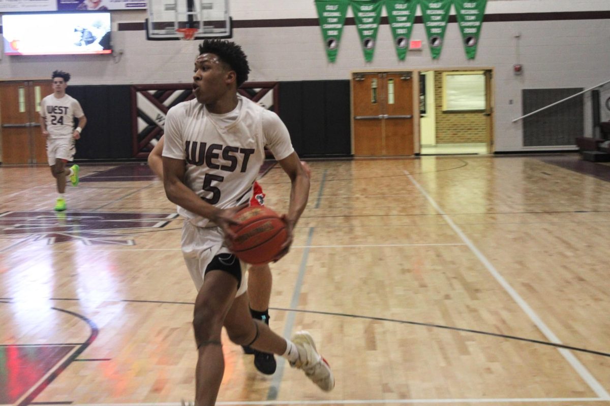 2023 Graduate Keishaun Pendleton goes in for a layup during the fourth quarter of the varsity game against the Western Dubuque Bobcats.