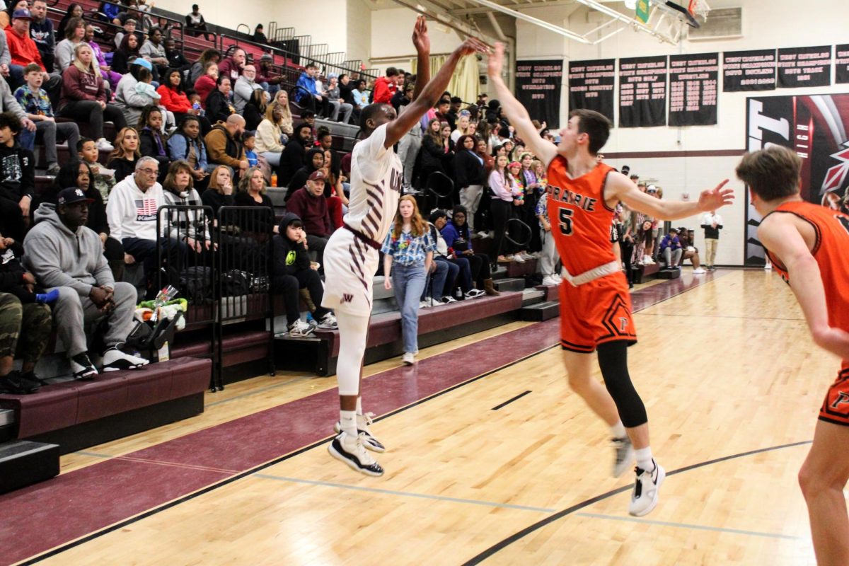 2023 graduate, Simarion Anderson, shoots a three point shot against Cedar Rapids Prairie during their senior night game. 