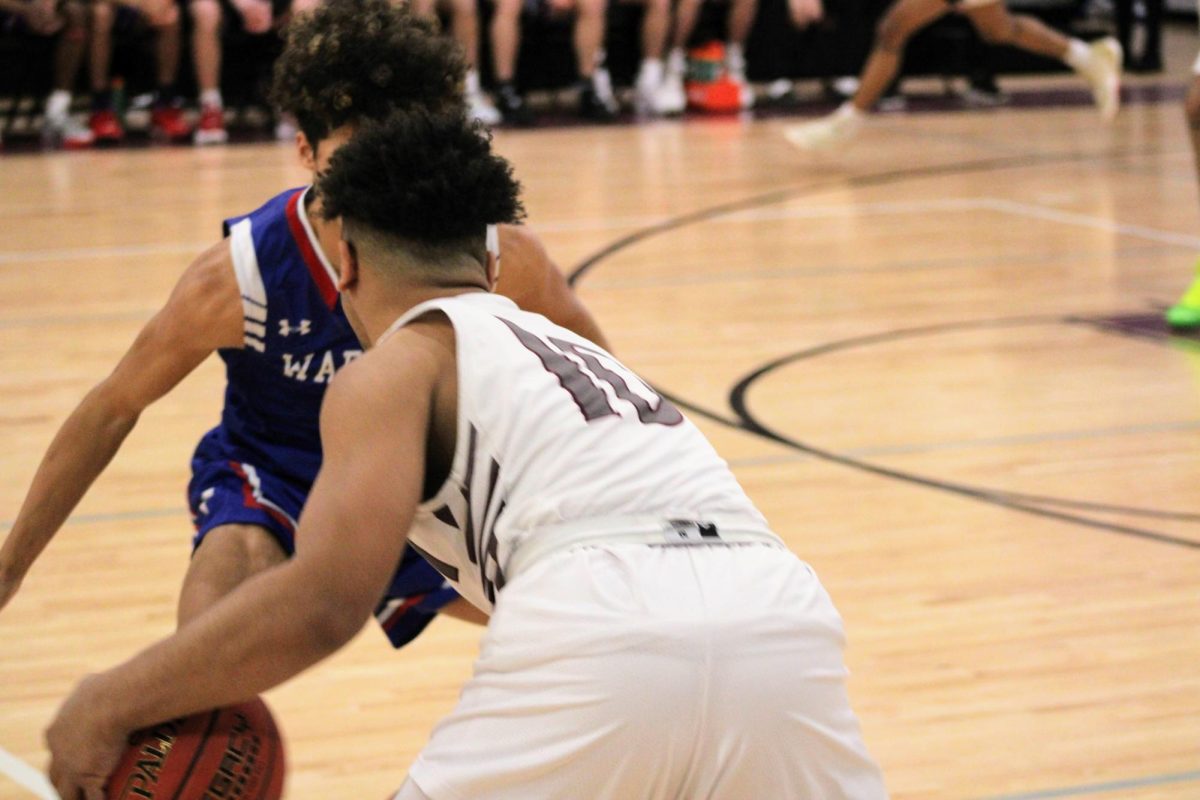 (2022-23) Junior Nasir Kuykendall goes head to head with a Cedar Rapids Washington athlete. 