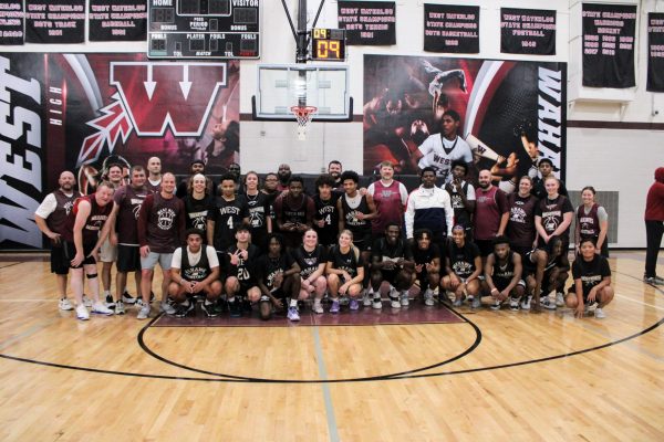 All athletes and coaches group together for a picture after the staff team takes down the seniors. 