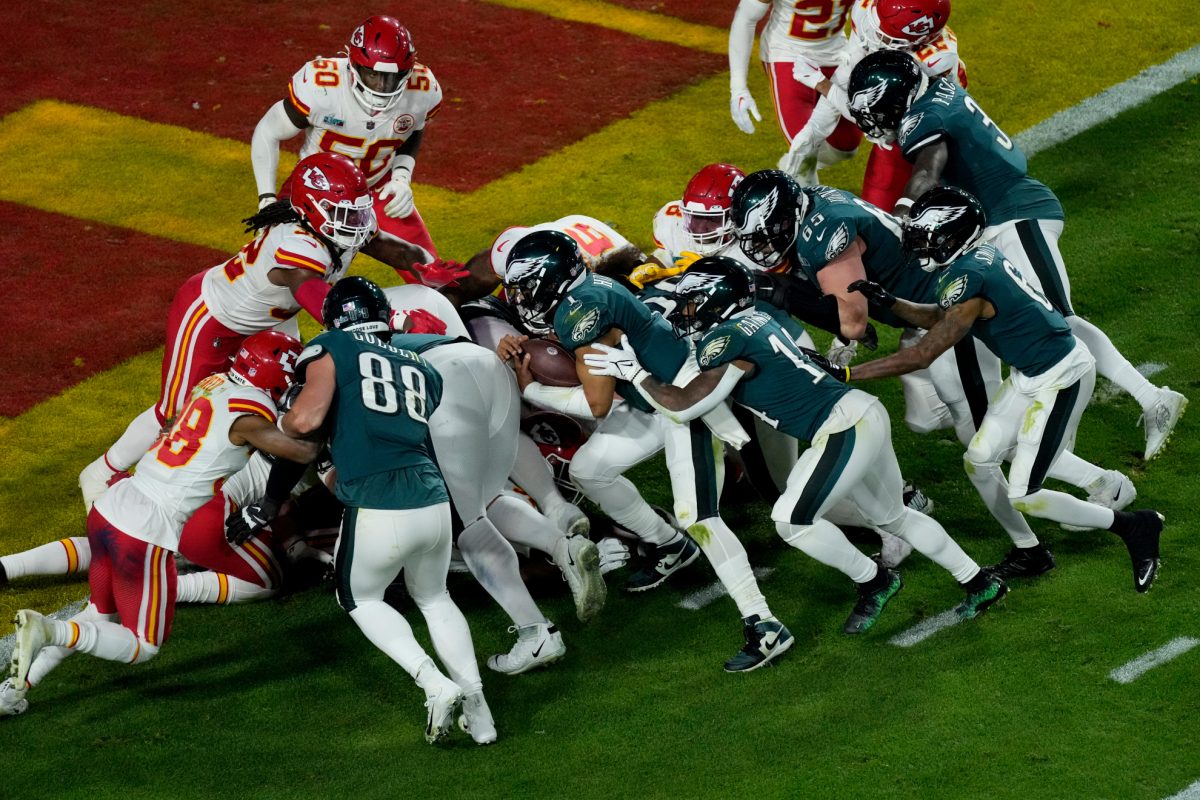 Philadelphia Eagles quarterback Jalen Hurts (1) rushes for a touchdown against the Kansas City Chiefs during the second half of the NFL Super Bowl 57 football game, Sunday, Feb. 12, 2023, in Glendale, Ariz. (AP Photo/Charlie Riedel)