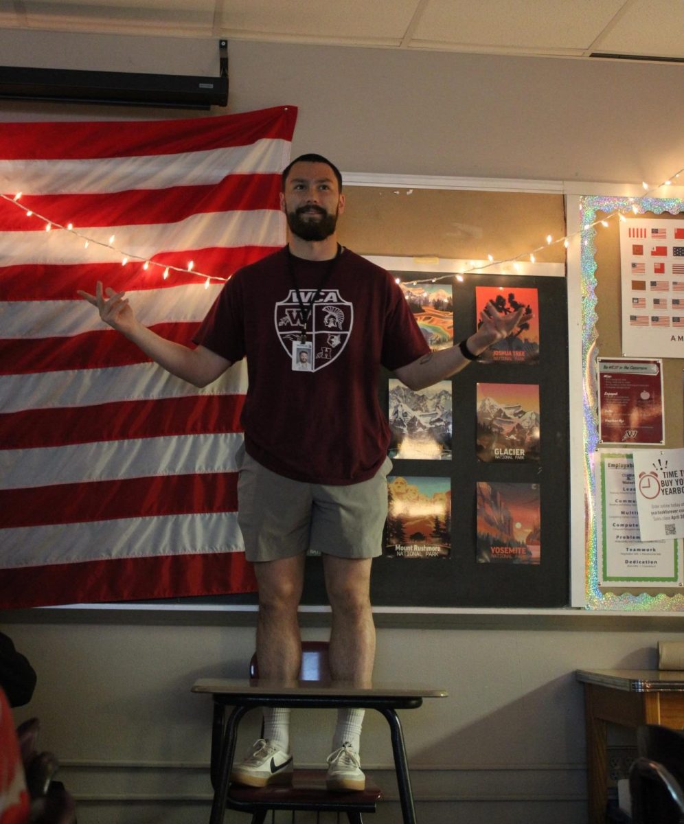 Jackson McNally stands on a desk during a US History lesson. 