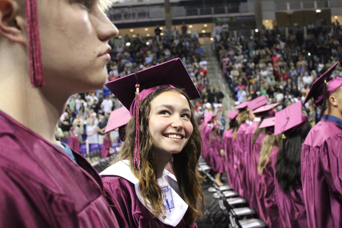 Scarlett Bertram smiles at her family once she makes her way to her seat at graduation. 