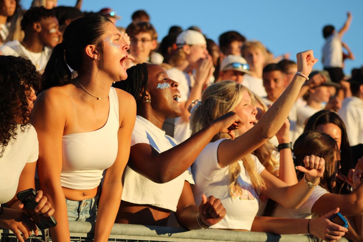 Seniors Emma Beckman, Jada Smith and Rachel Herbert booing the East High players in the Wahawk student section.