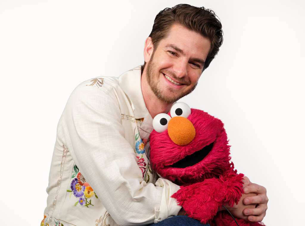 Actor Andrew Garfield hugging Elmo after their discussion about grief 