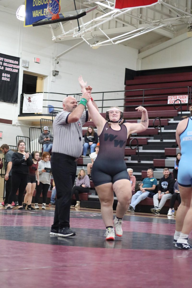 Reagan Westphal celebrating her win against a Cedar Rapids Jefferson wrestler.