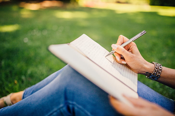 Woman journaling in a field