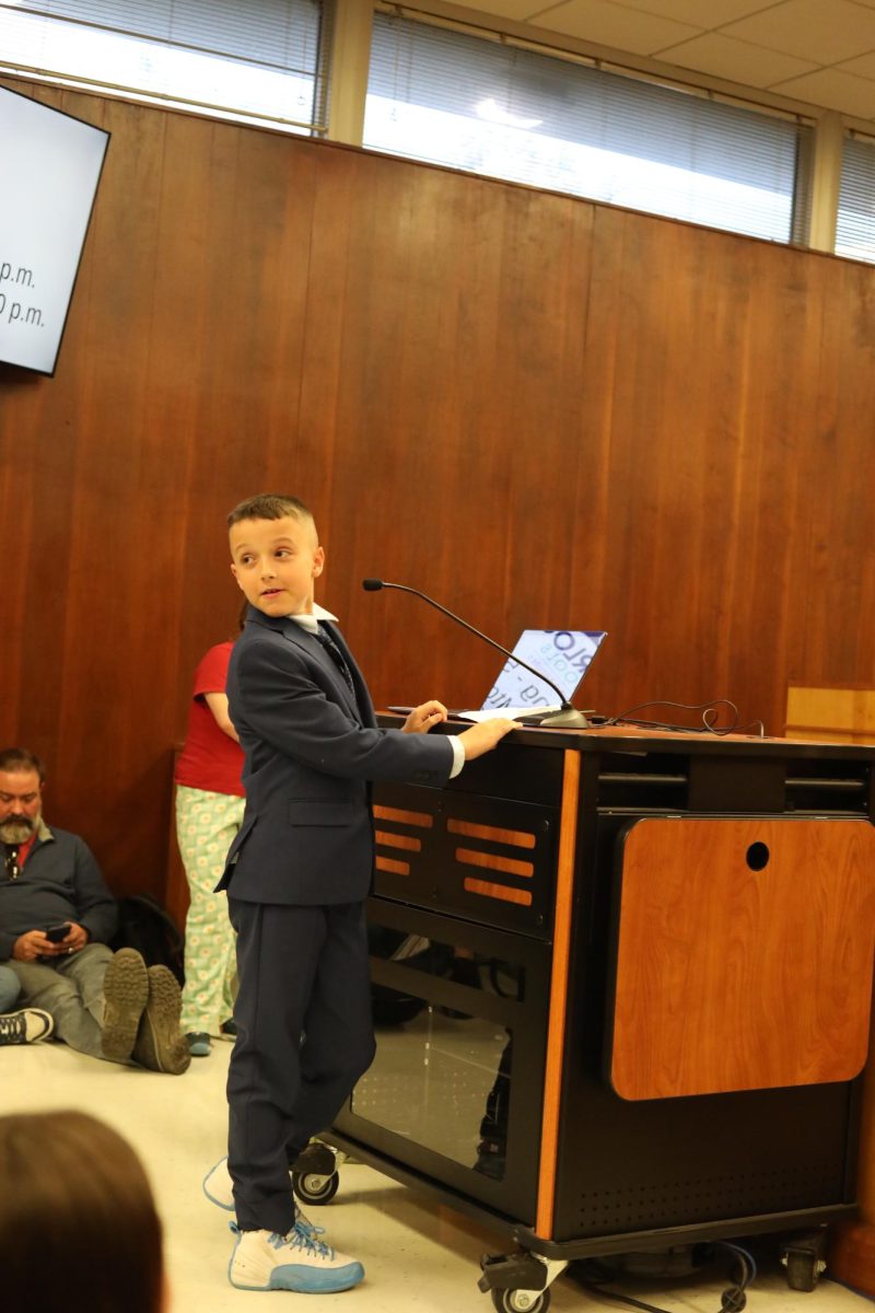 10-year-old Orange Elementary student Foster addresses the school board on March 24. "I'm just going to throw this straight out there, but librarians are one of the best teachers. And if you're just going to get rid of them, I would reconsider," he shares. Foster points out his librarian, Jane Castings, and praises her work in front of the board. "Sure you've got computers, sure you've got teachers, but librarians are just different. I think you should really reconsider," Foster concludes. 