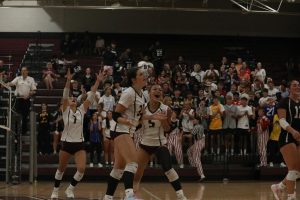 Volleyball team celebrates with Sophomore Kennedy Crawford after an impressive spike from the outside hitter. 