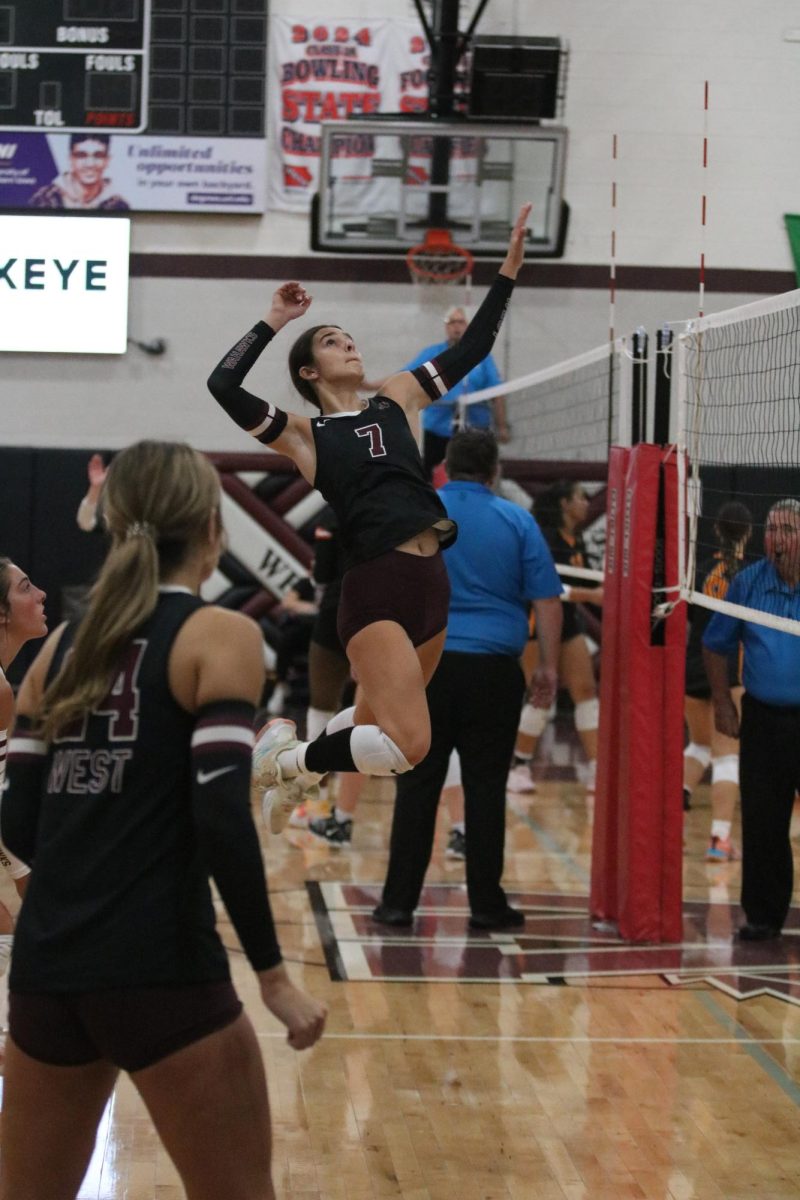 Sophomore Eliana Kudic spikes the ball at the Eileen Benninga Invite. 