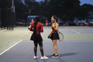 Junior Janet Toe and Sophomore Harper Doerder share a laugh during their doubles match against Cedar Falls on September 4th.