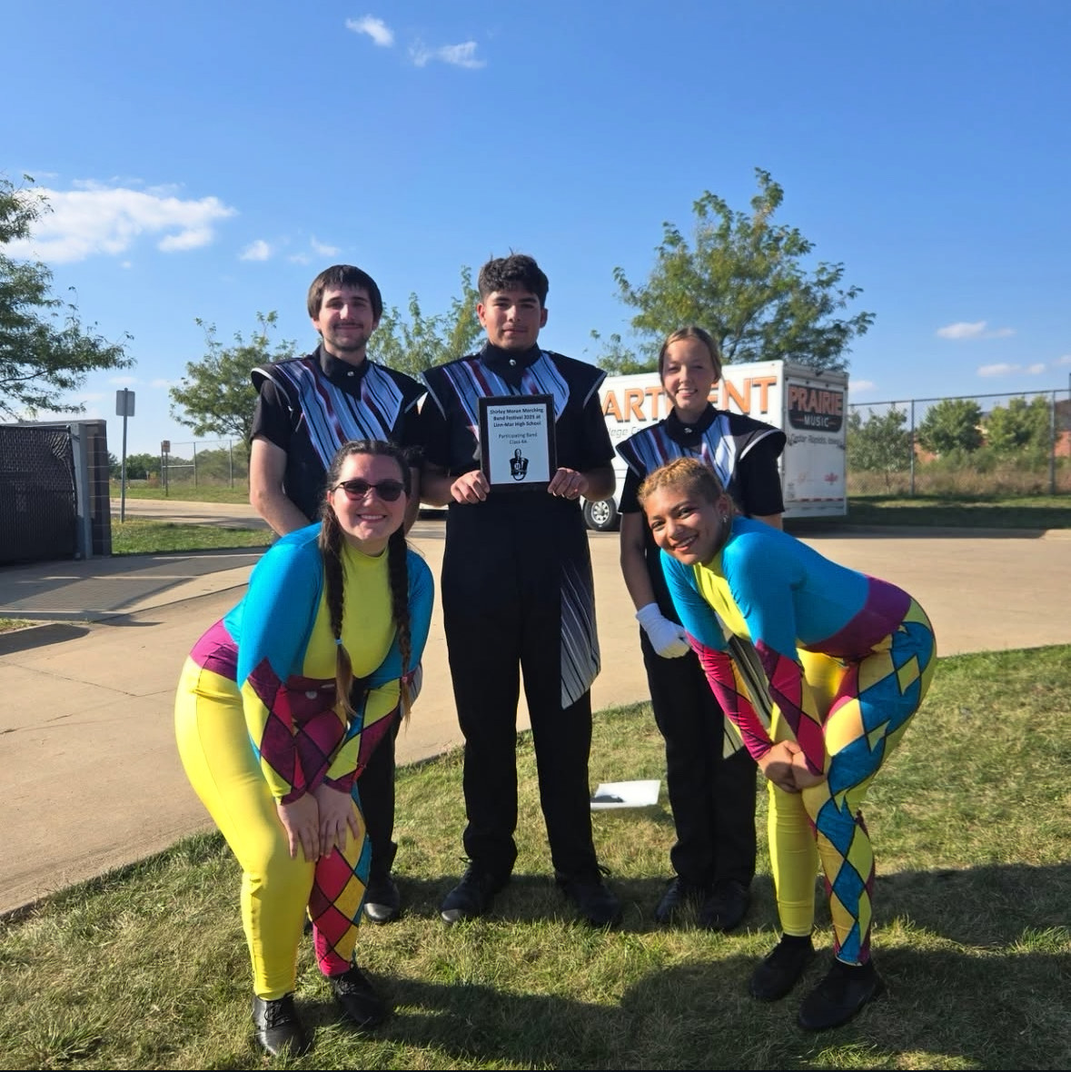 Drum majors Dean Hempel, Jaxon Thoms and Halle Evans pose with Color Guard Captains Brooklynn Berumez and Phinn Burt after the Linn-Mar Marching Festival awards ceremony. Photo courtesy of Jaxon Thoms. 