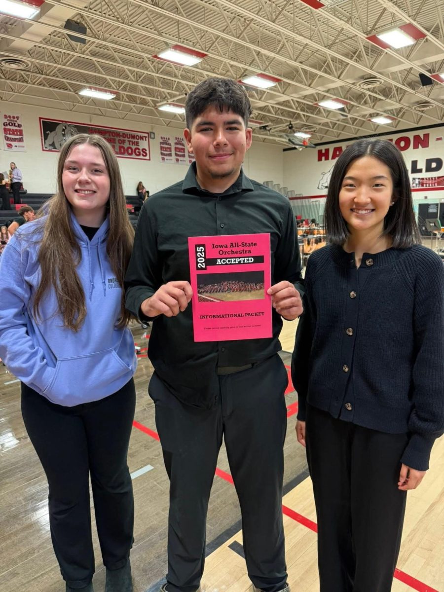 Junior Jaxon Thoms smiles with his All-State acceptance folder alongside fellow orchestra all-staters sophomore Phoebe Morgan and senior Esther Shin. Photo courtesy of Jaxon Thoms. 