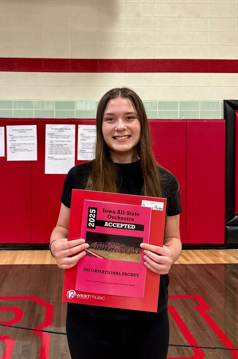 Sophomore Phoebe Morgan proudly presents her All-State acceptance folder for Orchestra. This is Morgan's second consecutive year achieving an All-State level. Photo courtesy of Phoebe Morgan. 