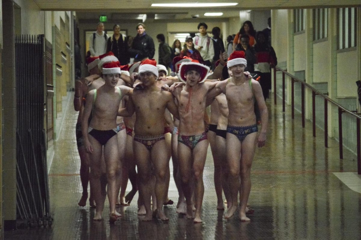 Members of the boys Swim team wrap their arms around each other's shoulders at the end of their run. They made their way back to the athletic hallway to get ready for their breakfast at Village Inn. 