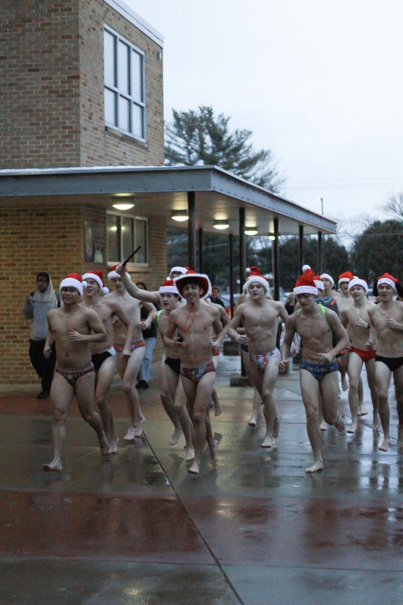 The Boys Swim Team reenters the building at the end of their annual Speedo run. 