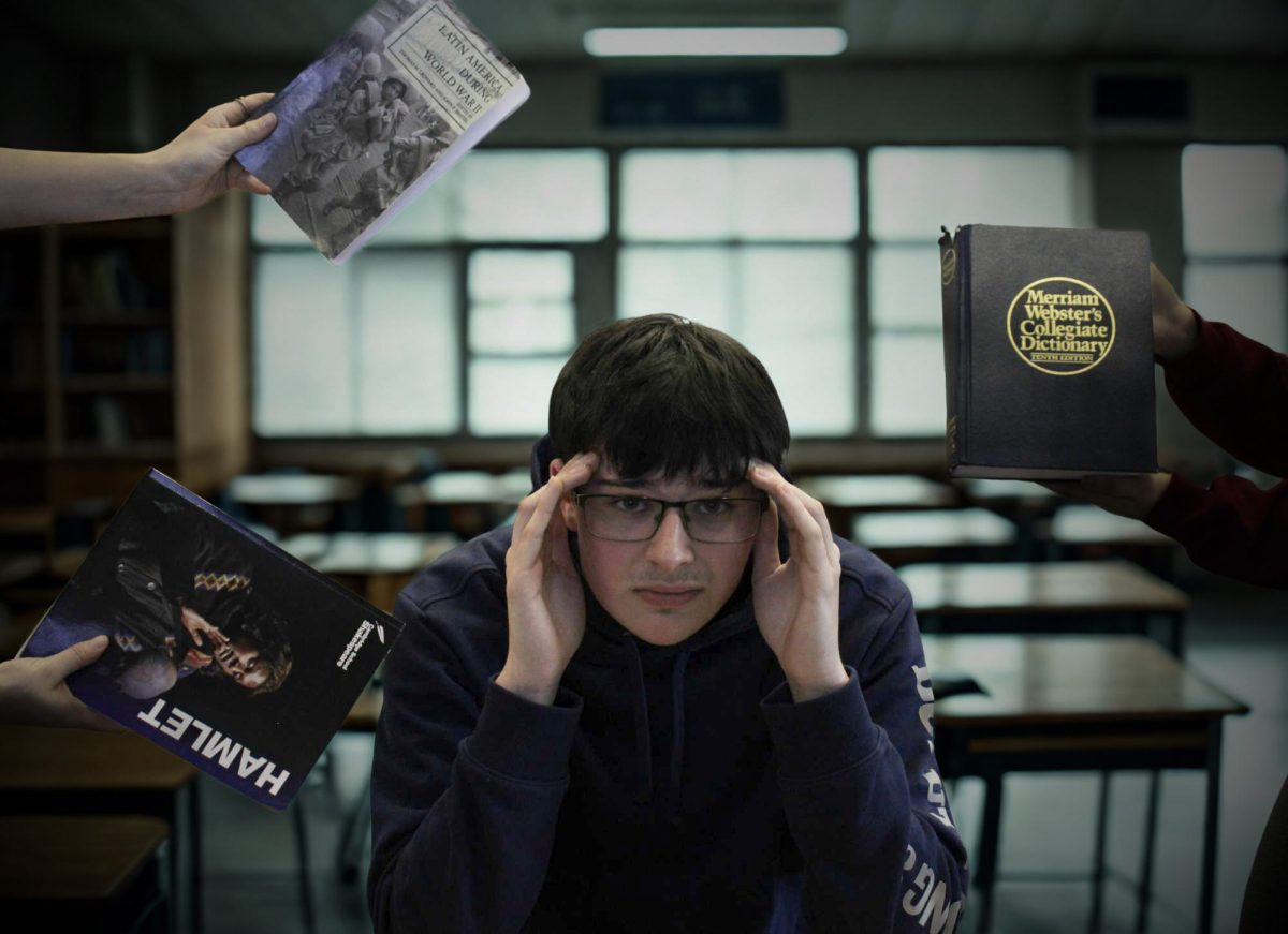  Senior, Alex Madonna is seen surrounded by his schoolbooks. The world is closing in on him as he is seen alone in his classroom stressed by all he has to do. 