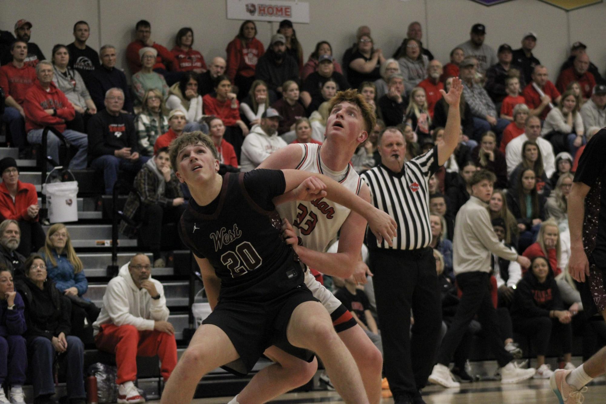 Junior Thomas Gettman boxing out his defender while awaiting to get a rebound.