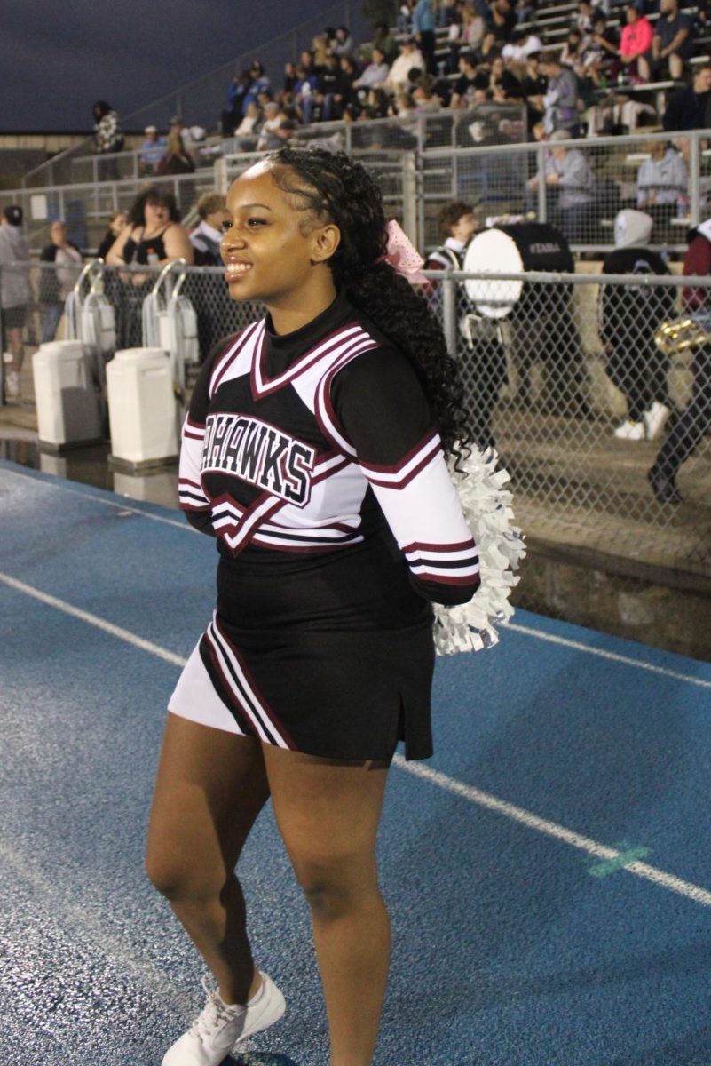 Njeri De Leon watches the game at Memorial Stadium while cheering. 