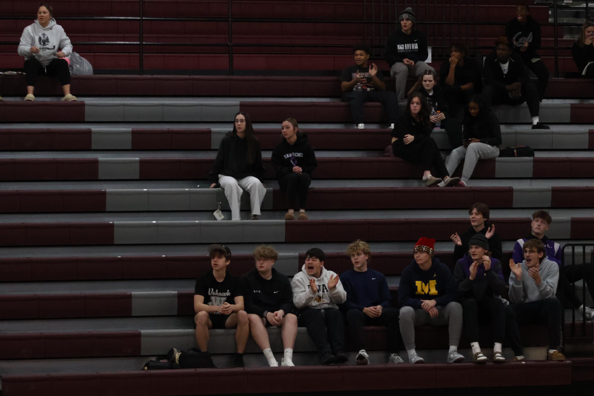 A small group of students at a girls basketball game against Xavier.