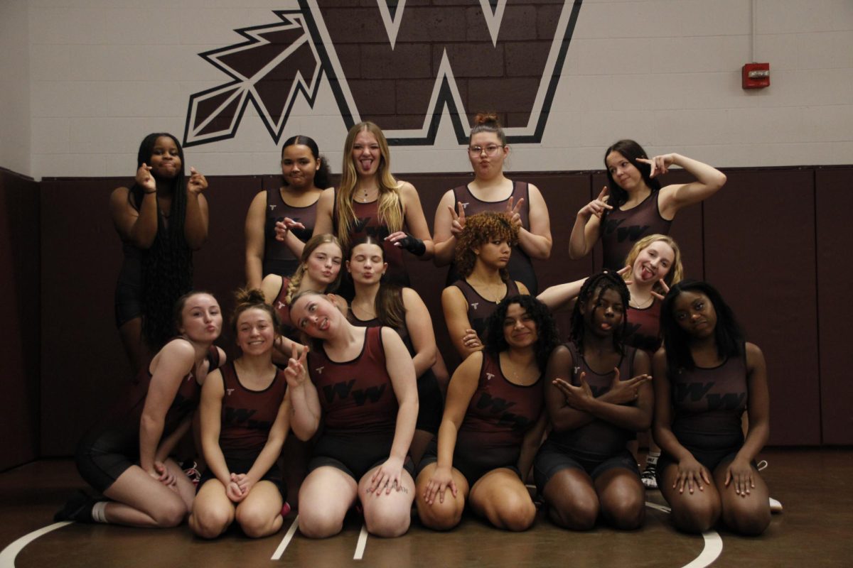 During a student led Girls Wrestling Media day the team posed for a "funny photo." This moment captures the relationships wrestling builds for athletes and the fun that being apart of the team provides. 