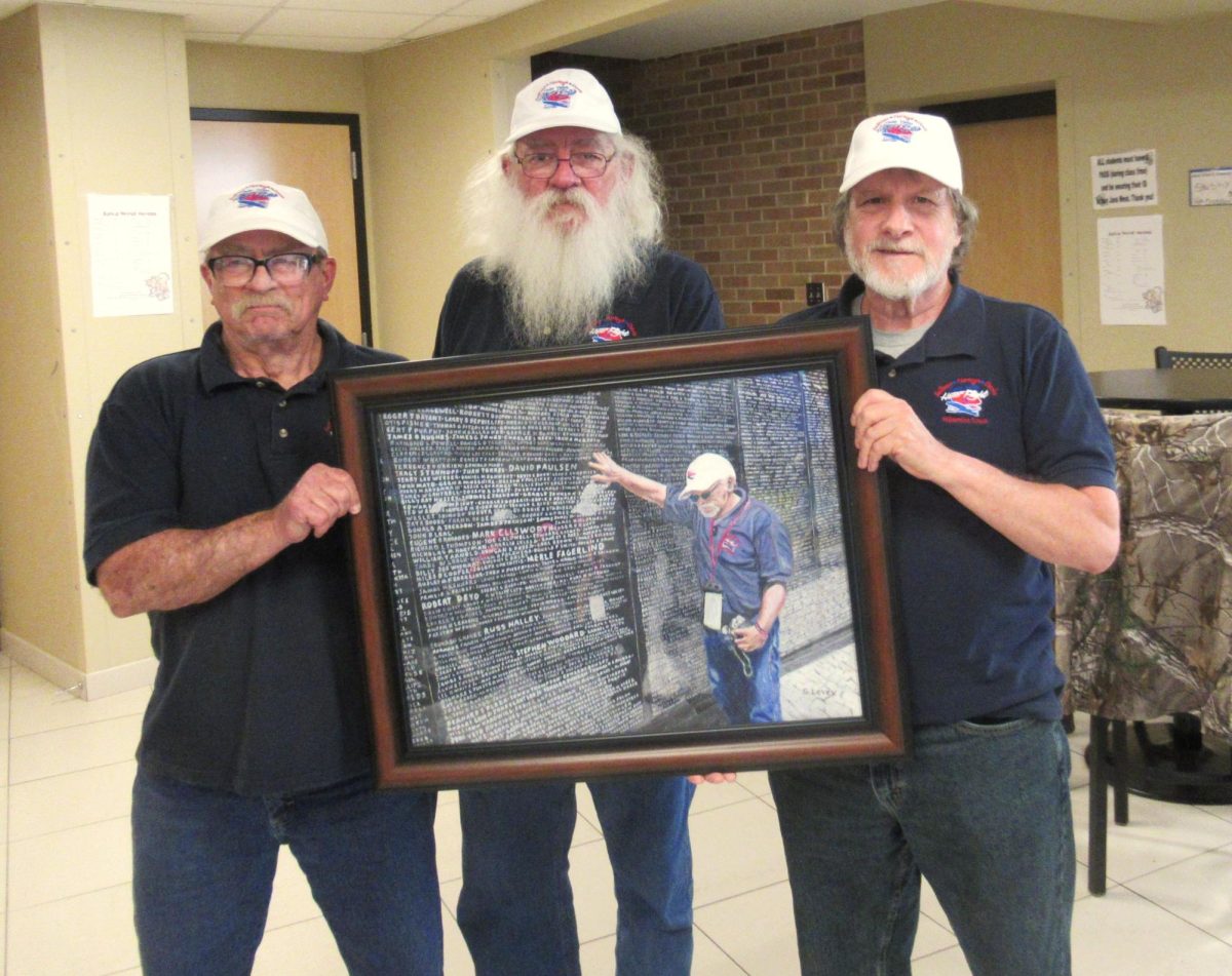Matt, Steve, and Larry pose with Levey's painting of Matt in Washington D.C. at the Vietnam Veterans Memorial. (Photo Courtesy of Stephen Levey)