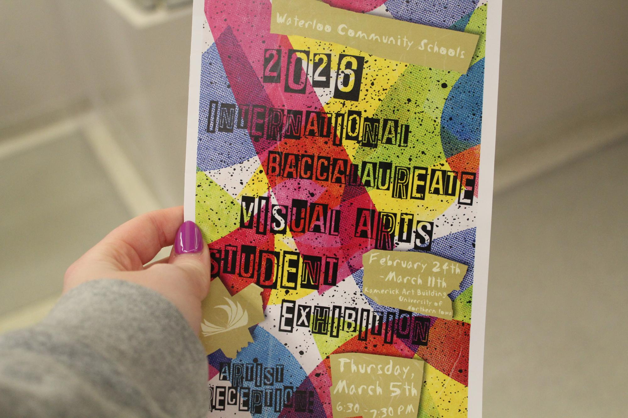 Kara Oberheu holds a program from the IB Art Showcase. Inside it shares extra details from the student's art. 
