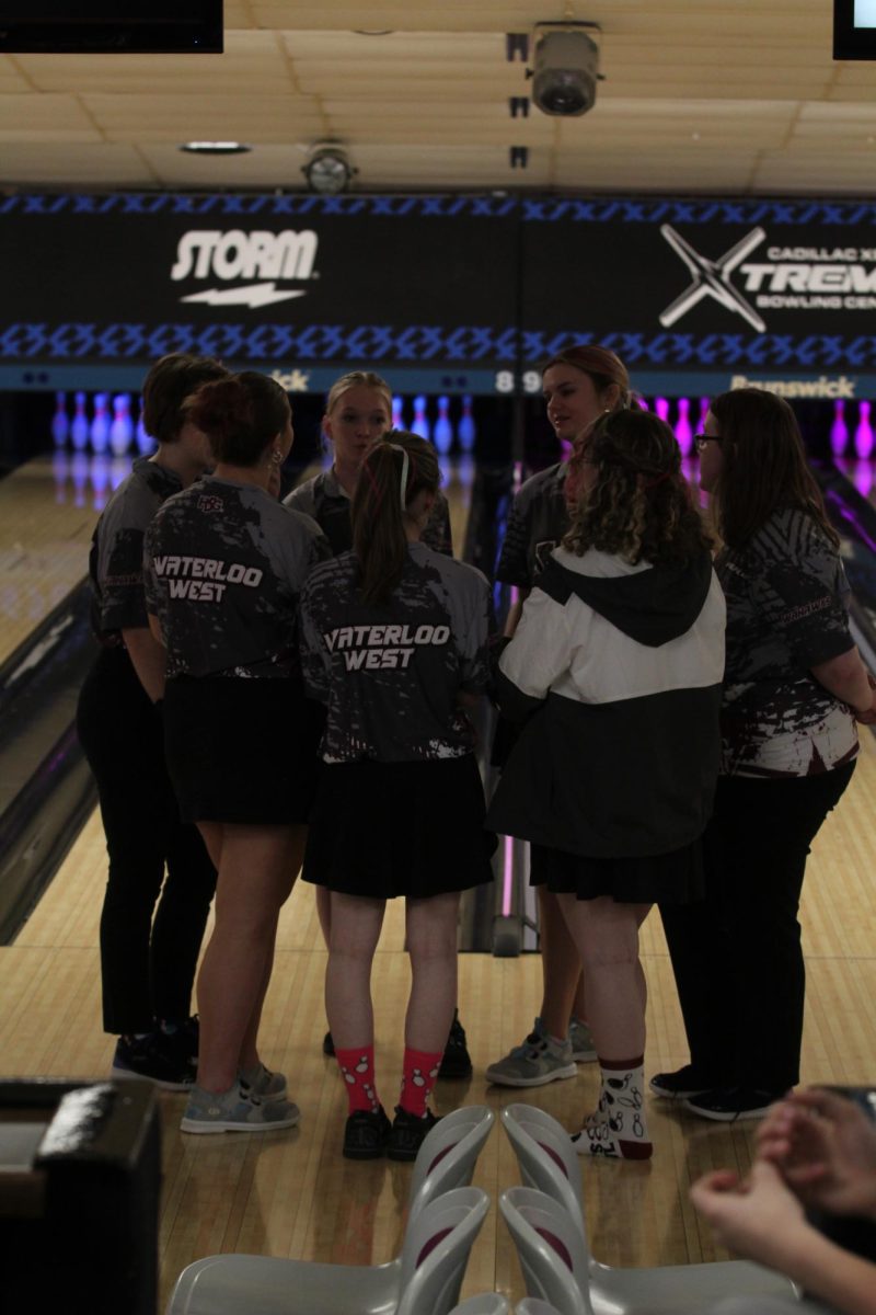 The girls bowling team strategizing before the team state tournament 