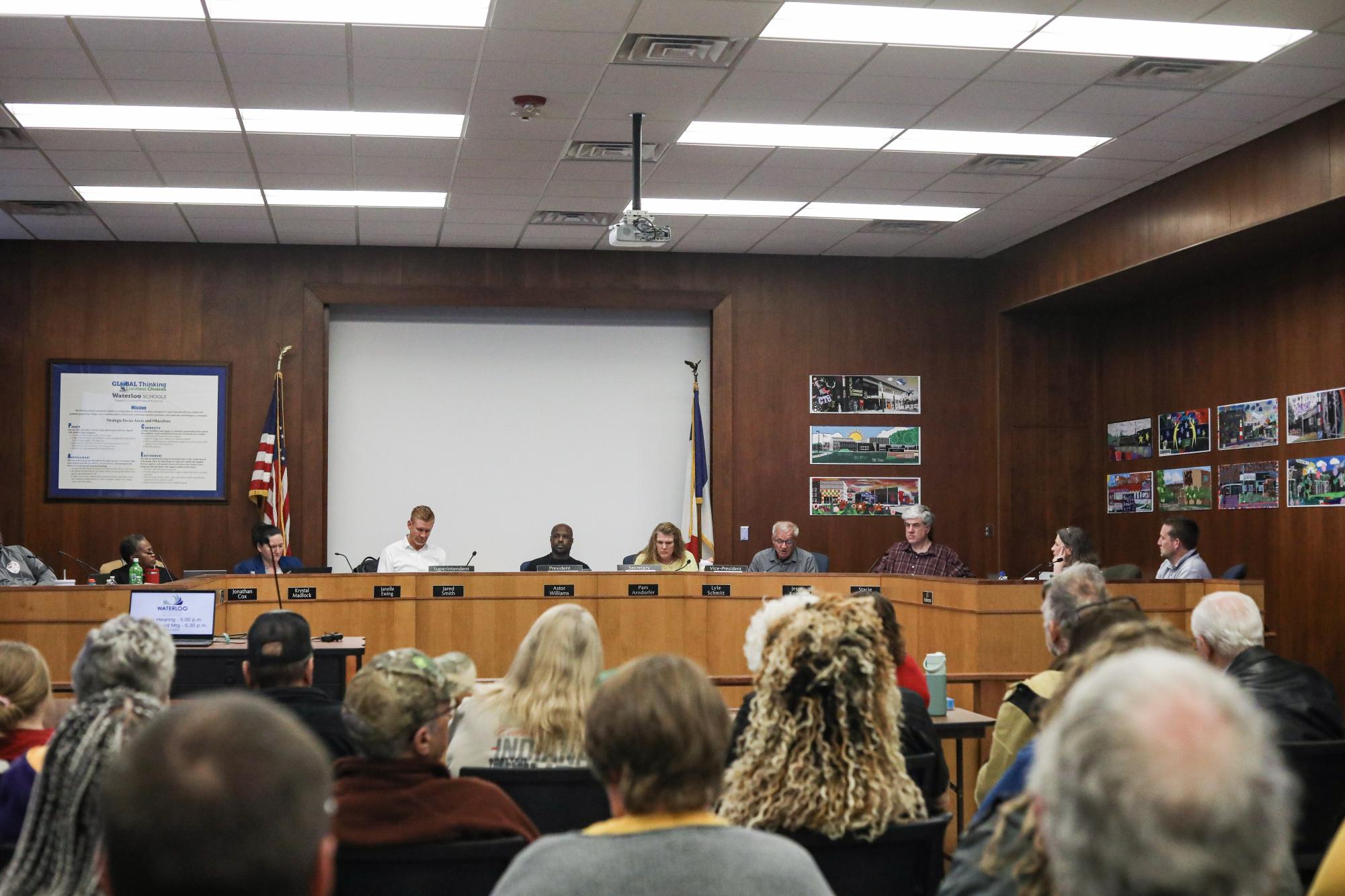 The Waterloo Community School District's board of education sits in front of the audience. During this meeting, many members of the district found out that their positions were in jeopardy and had potential to be cut. 