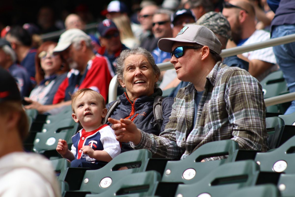 A family talks amongst themselves as they spend their time with the Minnesota Twins.